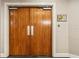 Large wooden double doors leading to 'The Wellesley Club' at 2305 Edgewater Dr # 1509, Orlando, FL 32804