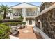 Outdoor fireplace with seating and tropical landscaping at 2305 Edgewater Dr # 1509, Orlando, FL 32804
