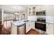 Bright kitchen with stainless appliances, white cabinets, island with blue granite counters and hardwood floors at 2305 Edgewater Dr # 1509, Orlando, FL 32804