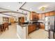 The kitchen features stainless steel appliances, wood cabinets, and an island with granite countertops for meal prep at 2305 Edgewater Dr # 1509, Orlando, FL 32804