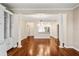 Open living space with hardwood floors, white columns, and sight lines to the kitchen at 2305 Edgewater Dr # 1509, Orlando, FL 32804