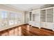 Open living area with hardwood floors, built-in shelving, and access to balcony at 2305 Edgewater Dr # 1509, Orlando, FL 32804