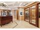 Hallway with tiled floors and wood paneled walls, featuring elevators and reception desk at 2305 Edgewater Dr # 1509, Orlando, FL 32804