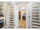 Open view into a walk-in closet and adjacent bathroom at 2305 Edgewater Dr # 1509, Orlando, FL 32804