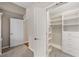 Spacious walk-in closet with ample shelving and drawer storage, plus two doors to additional rooms at 2305 Edgewater Dr # 1509, Orlando, FL 32804