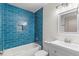 Bathroom featuring blue subway tile, shower and tub combination, and modern vanity at 25 Reflections Village Dr, Ormond Beach, FL 32174