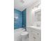 Bathroom featuring blue subway tile, shower and tub combination, and modern vanity at 25 Reflections Village Dr, Ormond Beach, FL 32174