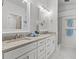 Modern bathroom with double sinks, granite countertops, and bright lighting, offering a luxurious feel at 25 Reflections Village Dr, Ormond Beach, FL 32174