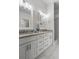 Modern bathroom with double sinks, granite countertops, and bright lighting, offering a luxurious feel at 25 Reflections Village Dr, Ormond Beach, FL 32174