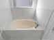 Luxurious bathtub with marble surround, perfect for relaxation and unwinding after a long day at 25 Reflections Village Dr, Ormond Beach, FL 32174