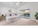 Bedroom featuring a queen-sized bed, sliding glass door, vaulted ceiling, and a modern ceiling fan at 25 Reflections Village Dr, Ormond Beach, FL 32174