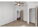 Cozy bedroom with neutral carpet, ceiling fan, closet, and doorway access to other rooms at 25 Reflections Village Dr, Ormond Beach, FL 32174