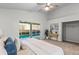 Bedroom featuring a queen-sized bed, sliding glass door, vaulted ceiling, and a modern ceiling fan at 25 Reflections Village Dr, Ormond Beach, FL 32174