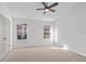 Bright bedroom with carpet, ceiling fan, neutral walls and two double hung windows at 25 Reflections Village Dr, Ormond Beach, FL 32174