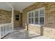 Covered porch with brick walls and tile floors, featuring large windows and a bright, open feel at 25 Reflections Village Dr, Ormond Beach, FL 32174