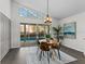 Dining room with views of the pool, modern lighting, and seating for four at 25 Reflections Village Dr, Ormond Beach, FL 32174