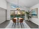 Dining room features modern lighting, a palm, and a view of the pool at 25 Reflections Village Dr, Ormond Beach, FL 32174