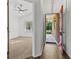 Inviting entryway featuring a bright red front door, hardwood floors, and a view into a bedroom at 25 Reflections Village Dr, Ormond Beach, FL 32174
