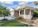 Charming one-story home with a brick facade, covered porch, and manicured landscaping at 25 Reflections Village Dr, Ormond Beach, FL 32174