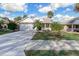 Inviting one-story home with a two-car garage, front porch, and well-maintained landscaping at 25 Reflections Village Dr, Ormond Beach, FL 32174