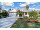 Inviting one-story home with front porch, brick accents, and well-maintained landscaping at 25 Reflections Village Dr, Ormond Beach, FL 32174