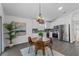 Open concept: dining area with a view of the kitchen featuring stainless steel appliances and white cabinetry at 25 Reflections Village Dr, Ormond Beach, FL 32174