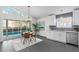 Bright and airy kitchen with stainless steel appliances, seamlessly connecting to the dining area and backyard pool at 25 Reflections Village Dr, Ormond Beach, FL 32174