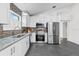 Bright kitchen with stainless steel appliances, granite counters, and tiled floor at 25 Reflections Village Dr, Ormond Beach, FL 32174
