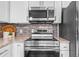 Modern kitchen features stainless steel appliances, granite countertops, and white cabinetry at 25 Reflections Village Dr, Ormond Beach, FL 32174