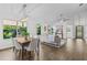 Open-concept living room with dining area featuring hardwood floors and ample natural light at 25 Reflections Village Dr, Ormond Beach, FL 32174