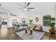 Sunlit living room boasts stylish decor, hardwood floors, neutral colors, and a ceiling fan at 25 Reflections Village Dr, Ormond Beach, FL 32174