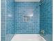 Shower featuring blue subway tile, shower and tub combination, and tiled niche at 25 Reflections Village Dr, Ormond Beach, FL 32174