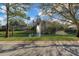 A scenic pond with a central fountain, enhanced by mature trees and landscaping at 25 Reflections Village Dr, Ormond Beach, FL 32174