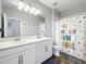 Bathroom with a double sink vanity, large mirror, and decorative shower curtain at 2676 Estuary Loop, Oviedo, FL 32765