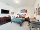 Well-lit bedroom with a wooden bed frame and sports memorabilia at 2676 Estuary Loop, Oviedo, FL 32765