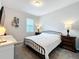 Clean bedroom with minimalist decor, featuring a full-size bed and a window for natural light at 2676 Estuary Loop, Oviedo, FL 32765
