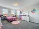 Bedroom offers gray carpet, white trim, and two windows for ample light at 2676 Estuary Loop, Oviedo, FL 32765