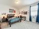 Bedroom features a wooden bed frame, a desk, and sports-themed decor at 2676 Estuary Loop, Oviedo, FL 32765