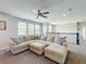 Bright bonus room with plush seating, a ceiling fan, and large windows to maximize the natural light at 2676 Estuary Loop, Oviedo, FL 32765