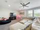 Bright bonus room with plush seating, a ceiling fan, and large windows to maximize the natural light at 2676 Estuary Loop, Oviedo, FL 32765