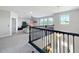 View from landing to see the spacious bonus room with natural lighting and decorative wrought iron banister at 2676 Estuary Loop, Oviedo, FL 32765