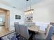 Formal dining room featuring chair rail, decorative lighting, and an accent rug at 2676 Estuary Loop, Oviedo, FL 32765