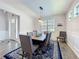 Dining room features wainscoting detail, a stylish chandelier, and wood-look tile floors at 2676 Estuary Loop, Oviedo, FL 32765