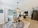 Open dining area with a view to the outdoor pool and modern living room at 2676 Estuary Loop, Oviedo, FL 32765