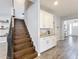 Inviting entryway featuring wood flooring and staircase adjacent to a dry bar at 2676 Estuary Loop, Oviedo, FL 32765