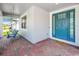 Inviting front porch features a swing and a vibrant blue front door that welcomes visitors at 2676 Estuary Loop, Oviedo, FL 32765