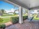 Inviting front porch features a swing and a view of the well-maintained neighborhood street at 2676 Estuary Loop, Oviedo, FL 32765