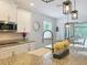 Open concept kitchen with granite counters, white cabinets, stainless appliances, and pendant lights at 2676 Estuary Loop, Oviedo, FL 32765