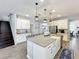 Spacious kitchen with a large island, granite countertops, and stainless steel appliances at 2676 Estuary Loop, Oviedo, FL 32765