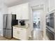 Bright kitchen features white cabinets, stainless steel appliances, and granite countertops at 2676 Estuary Loop, Oviedo, FL 32765